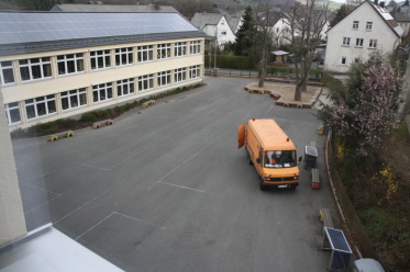 Foto vom Schulhof mit Bauamtfahrzeug